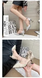 Detail view of elegant pointed-toe block heel sandals with pearl strap and glitter finish.