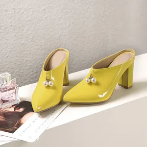 Elegant bright yellow patent leather high heel mules featuring pearl bead ornaments