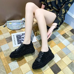 Detailed view of women's black rhinestone sneakers with thick platform chunky soles
