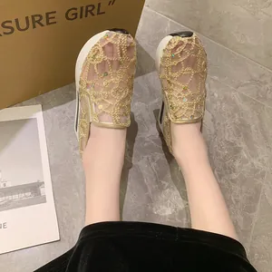Detail of golden lace mesh platform loafers with sequins for a stylish spring look.