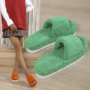 Soft vibrant green and orange fuzzy toweling slippers with thick platform soles shown on model