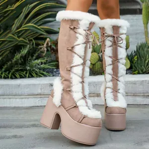Detail of beige suede Lolita snow boots with white faux fur trim and thick platform