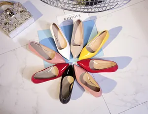 Detailed view of pointed-toe patent leather pumps in various vibrant colors