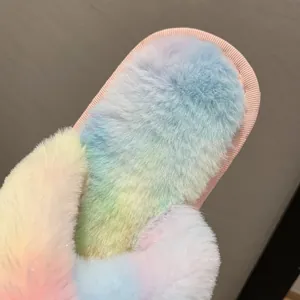 Macro detail showing the soft gradient rainbow faux fur texture of indoor plush slippers
