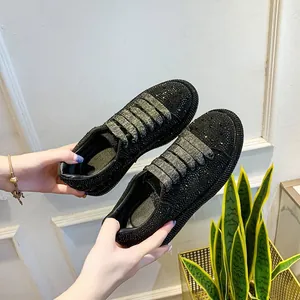 Close-up view of black rhinestone-encrusted platform sneakers for women