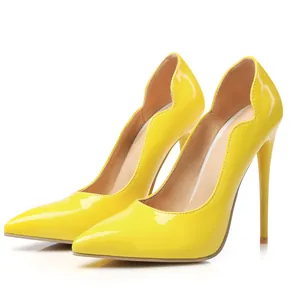 Vista lateral de elegantes tacones de charol amarillo con bordes festoneados y tacón de aguja