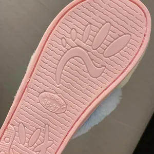 Close-up of the anti-slip pink sole on a furry indoor slipper for women