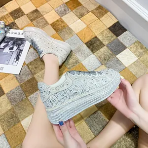 Detailed macro view of sparkling silver rhinestone platform sneakers with thick white soles