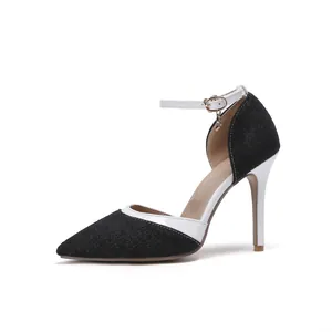 Detail of denim pointed-toe stiletto heels with white ankle strap and charm.