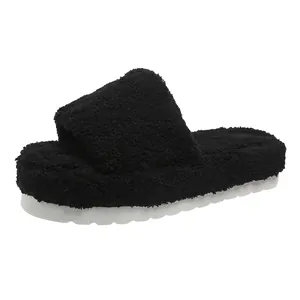 Side view of black plush slippers with a thick white platform sole for winter warmth