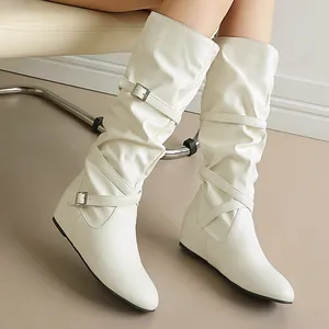 Detail view of stylish white slouchy mid-calf boots with decorative buckle straps.
