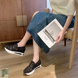 Detail of women's black lace mesh slip-on shoes with thick white platform sole