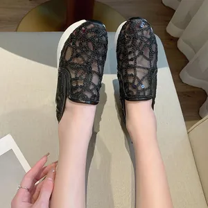 Macro view showing the intricate black lace mesh and sequins on women's platform loafers