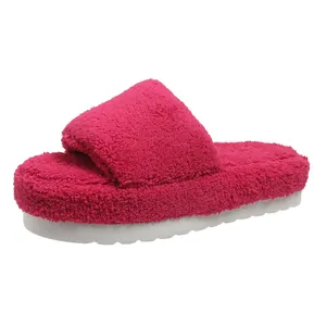Macro detail of soft magenta fuzzy platform slippers with a thick warm white sole.