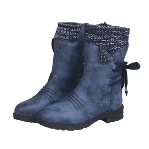 Detailed side view of blue mid-calf boots with knitted collar and lace-up back