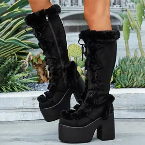 Close-up view of black Gothic Lolita platform winter boots featuring faux fur trim and lace-up design
