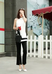 Elegant white pointed-toe high heels worn by a woman in a professional business outfit