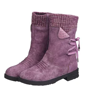 Close-up detail view of purple mid-calf boots with knitted collar and studded accent