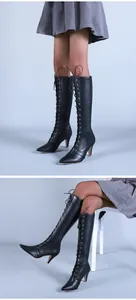Vue détaillée de bottes hautes noires à lacets avec talons aiguilles et bout pointu.