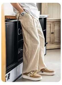 Close-up of men's thick-soled woven leather casual shoes paired with beige pants.