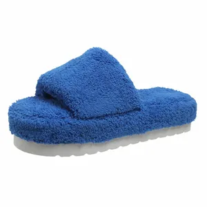 Cozy blue fuzzy faux fur slippers featuring a thick white platform sole for winter