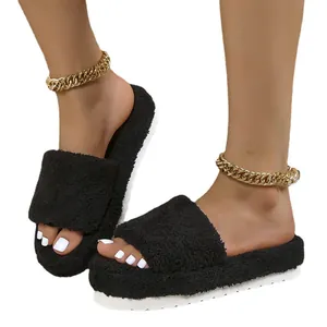 Stylish black fuzzy platform slides for women featuring soft faux fur and thick white soles