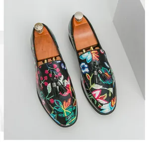 Close-up of the intricate floral embroidery and tassel details on men's loafers