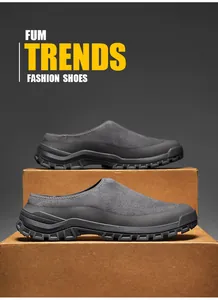 Detailed view of men's grey suede casual clogs with thick black rubber soles for outdoors