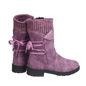 Detail view of purple mid-calf boots featuring knit collar and rear lace-up design.