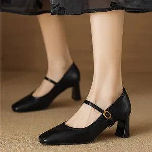 Close-up of black vintage square-toe Mary Jane block heel pumps with ankle strap.