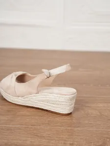 Detailed view of women's closed-toe wedge sandals with rope-wrapped platform