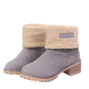 Detailed view of women's grey winter snow boots with warm fleece cuffs and lug soles