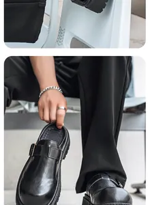 Vista detallada de zuecos de cuero negro para hombre estilo Birkenstock con hebilla
