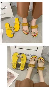Detailed view of yellow flat sandals with pearl pineapple and ruffled straps