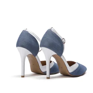 Detailed rear view of blue denim and white leather stiletto heels with ankle straps