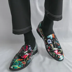 Stylish men's floral embroidered loafers featuring decorative tassels and slip-on style