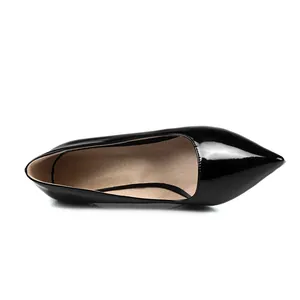 Detailed view of elegant black patent leather pointed toe pumps for professional wear