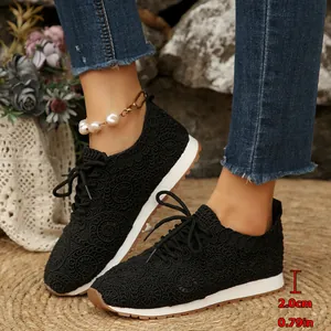Detail shot of black mesh lace-up sneakers highlighting the comfortable 2.0cm platform sole