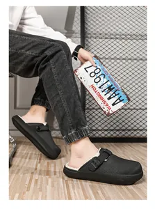 Detail view of men's black fleece-lined clogs with thick soles and adjustable strap