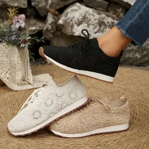 Detailed view of women's floral lace mesh sneakers in black, white, and beige colors