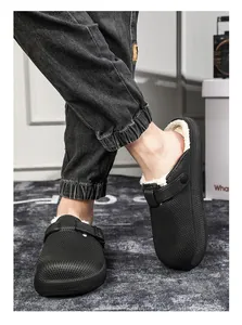 Close-up of men's black fleece-lined clogs with thick warm fur interior