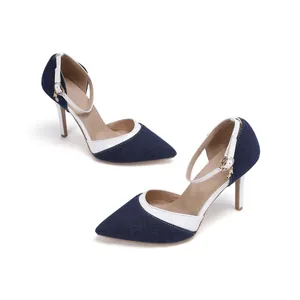 Detail view of pointed-toe denim stilettos featuring white piping and ankle straps