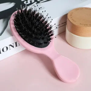 Detail showing mixed boar bristles and nylon pins of the pink massage hairbrush