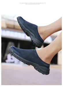 Side view detail of navy blue suede slip-on men's clogs featuring a thick anti-slip rubber sole