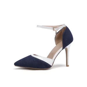 Detailed side view of navy denim and white leather pointed toe ankle strap stiletto heels