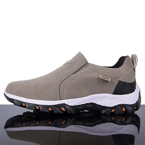 Detailed side profile view of mens gray suede outdoor casual hiking shoes on mirror surface