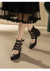 Detailed view of retro black Mary Jane pumps with multi-buckle straps worn by a model