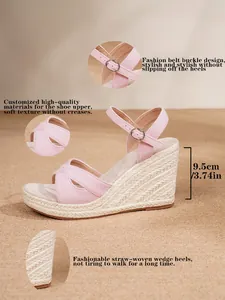 Detail view of pink espadrille wedge sandals with 9.5cm straw-woven heel and ankle strap