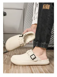 Close-up of beige fleece-lined clogs with buckle strap and non-slip thick sole.