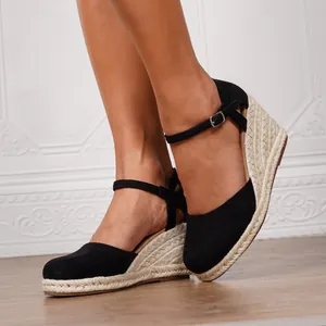 Eleganti sandali espadrillas neri con zeppa e suola in iuta intrecciata alla moda.